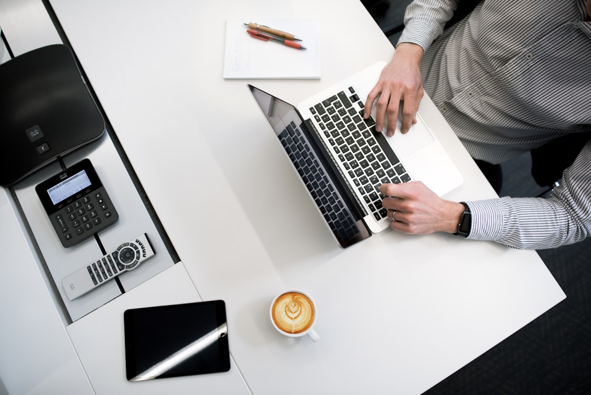 Professional reviewing bank statements at office desk